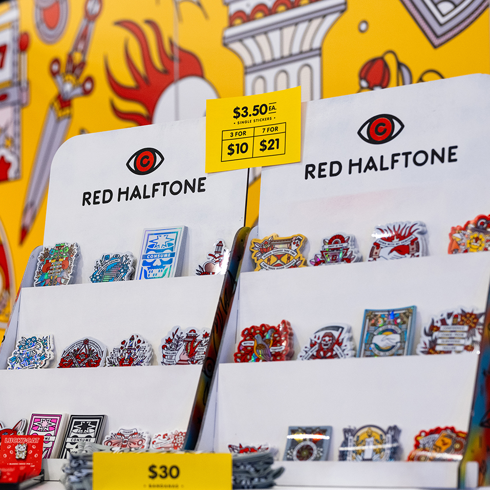 Ausstellungsstand mit bunten Freiform-Aufklebern von "Red Halftone" vor einem lebhaften Hintergrund.